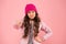 Bullying and shaming. Little girl winter clothes pink background. Childhood concept. Emotional girl long hair knitted