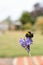 A  bumblebee on lavender flowers with a grass lawn, and gazebo in soft focus in the background with copy space