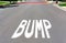 BUMP warning sign painted on residential street surface