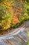 Bumpy Dirt Road Winds up Autumn Hillside