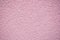 Bumpy and grainy pink wall for backgrounds and texture