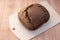 A bun of fresh black Borodino bread baked in a bread machine. Aromatic homemade cakes