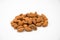 A bunch of Almond nuts laying on a white isolated background