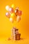 Bunch of balloons that are on top of block of wood on yellow background. Generative AI