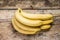 Bunch of Bananas on Wood Background. Top View