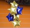 Bunch of Blue and Yellow Mylar Balloons with orange wall
