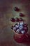 Bunch of blueberried in rusty metal jug on dark stone concrete background. Scattered berries. Creative toned image with copy space