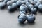 Bunch of blueberry berries close-up on a dark stone background