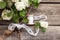 Bunch, bouquet of white flowers with lace on dark aged weathered wooden background