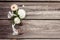 Bunch, bouquet of white flowers with lace on dark aged weathered wooden background