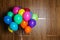 Bunch of bright balloons on wooden background