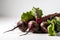 A bunch of bright young beets with green foliage on a pure white background