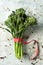 Bunch of broccolini on a stone surface