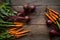 A bunch of carrots and beetroots . Fresh carrots, beetroot  heap with green stems. Raw Carrots and beetroot on rustic  wooden back