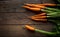 A bunch of carrots . Fresh carrots, beetroot  heap with green stems. Raw Carrots and beetroot on rustic  wooden back