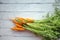 A bunch of carrots . Fresh carrots, beetroot  heap with green stems. Raw Carrots and beetroot on rustic  wooden back