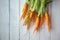 A bunch of carrots . Fresh carrots, beetroot  heap with green stems. Raw Carrots and beetroot on rustic  wooden back