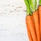 A bunch of carrots. Fresh carrots heap with green stems. Raw Ca