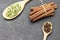 Bunch of cinnamon sticks and cardamom in wooden spoon, cloves in spoon