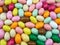 Bunch colored sugared almonds closeup background