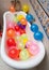 Bunch of colorful balloons in bath tube. Large pile of multicolored inflated balloons