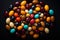 a bunch of colorful candy beans on a black background