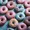 a bunch of colorful donuts on a blue surface