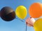 Bunch of Colorful Metallic Balloons Flying in the Air with Clear Blue Sky Background