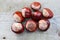 Bunch of conkers laying on a wooden table