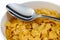 Bunch of corn flake cereals with a metal spoon