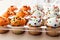 Bunch Of Cupcakes With Vanilla Cream Colored In Orange And White