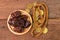 Bunch of dates, Islamic prayer beads and coins on wooden board. Ramadan kareem festive