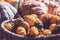 Bunch of decorative mini pumpkins and gourds in baskets on farmers market; autumn background