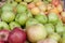 Bunch of different organic apple types displayed on sale on farmer`s market stand show richness and diversity