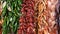 Bunch of different red yellow green brown chili peppers over the counter of the market of La Boqueria, Spain. Pepper for