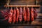 A bunch of different types of sausage hanging on a line. Dried and smoked sausage of various varieties. Wide range of meat