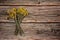 A bunch of dried tansy grass Tanacetum vulgare on a wooden background.