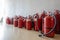 Bunch of expired fire extinguishers on the floor next to the wall. Renewal of extinguishers for businesses