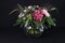 A bunch of flowers with Gerberas, roses and hydrangeas on black background