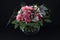 A bunch of flowers with Gerberas, roses and hydrangeas on black background