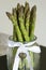 Bunch of fresh asparagus officinalis plant upright in decorative jar