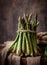 Bunch of fresh asparagus on rustic background.