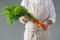 Bunch of fresh carrots in manâ€™s hands.