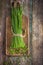 Bunch of fresh chives on a wooden cutting board