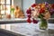 a bunch of fresh flowers on a marble countertop in a well-equipped kitchen