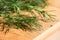 Bunch of fresh organic dill on a rustic wooden background with d