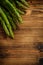 Bunch of fresh raw garden asparagus on wooden table background.