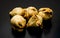 A bunch of fried samosas on a textured dark background