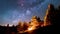 Bunch of friends sitting over campfire in summer nature forest under magic milky way galaxy stars Astronomy Space Time