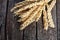 Bunch of golden ears of wheat on wood